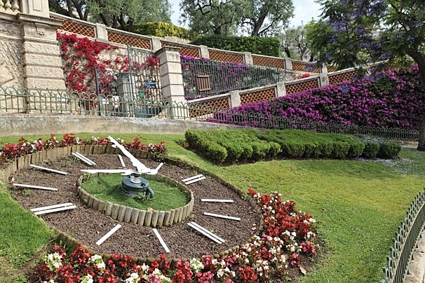 a garden clock & park entrance in monaco