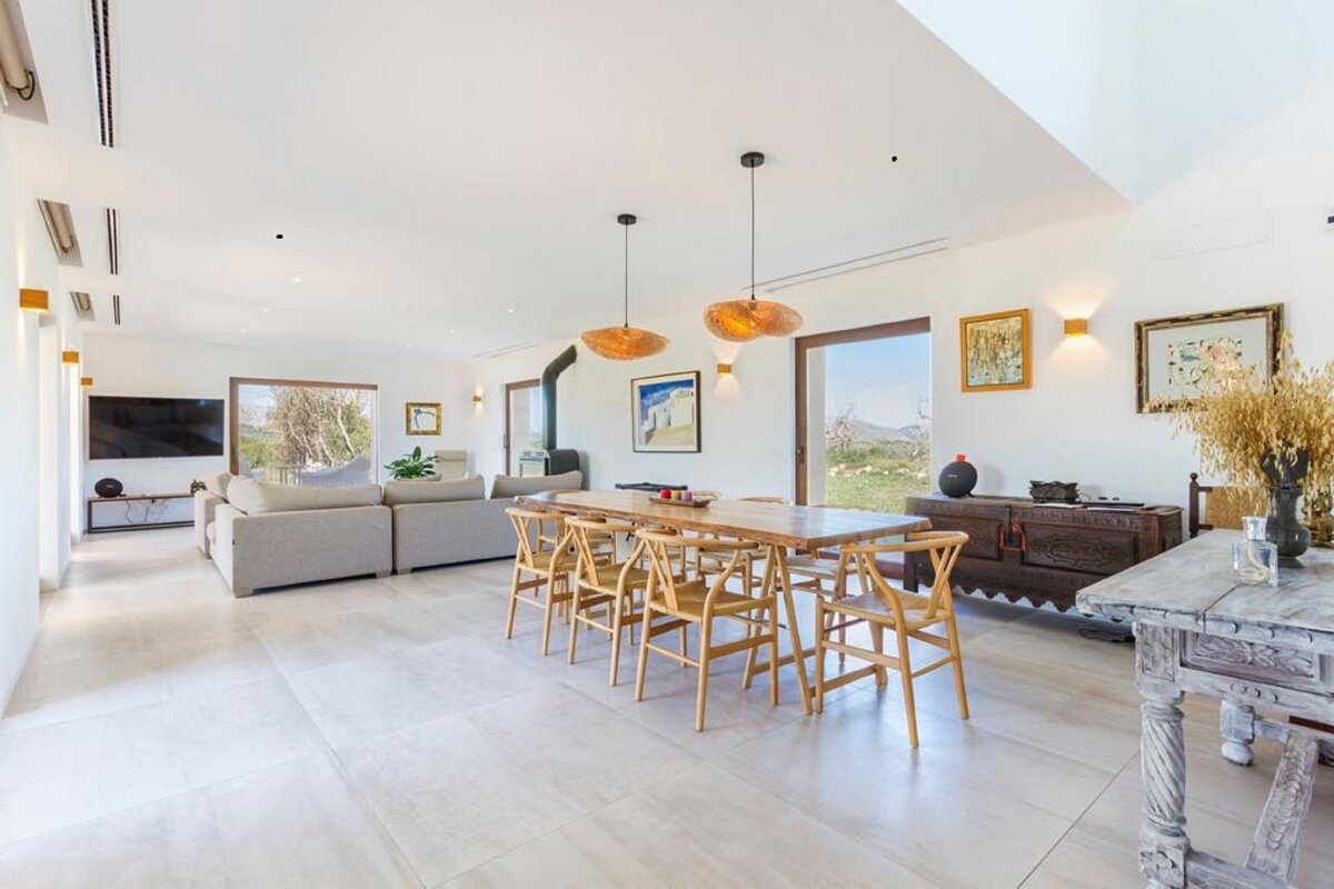 A living room with a dining table and chairs
