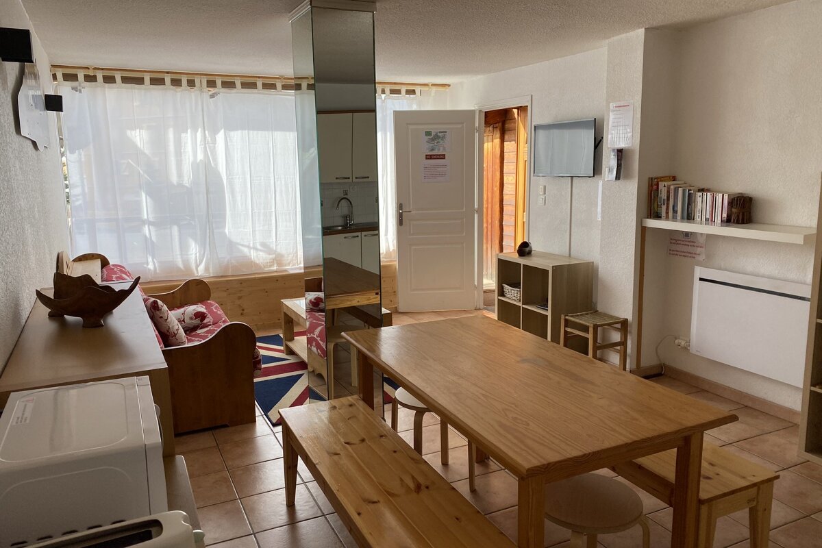 A living room with a wooden table and benches