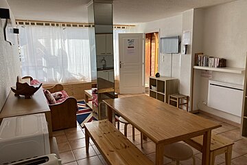 A living room with a wooden table and benches