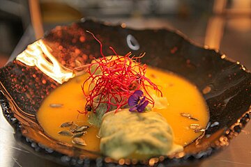 A close up of a plate of food with a flower on it