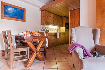 A living room with a wooden table and chairs