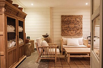 A room with wooden furniture and a painting on the wall