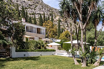 A large house with a lush green lawn in front of it