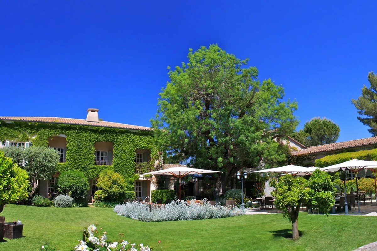 A large house with umbrellas in front of it