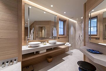 A bathroom with two sinks and a large mirror