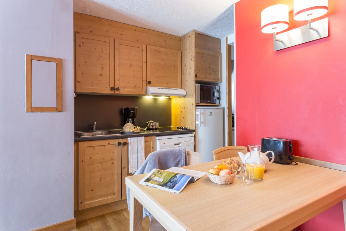 A kitchen with wooden cabinets and a fridge that says electrolux