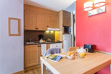 A kitchen with wooden cabinets and a fridge that says electrolux