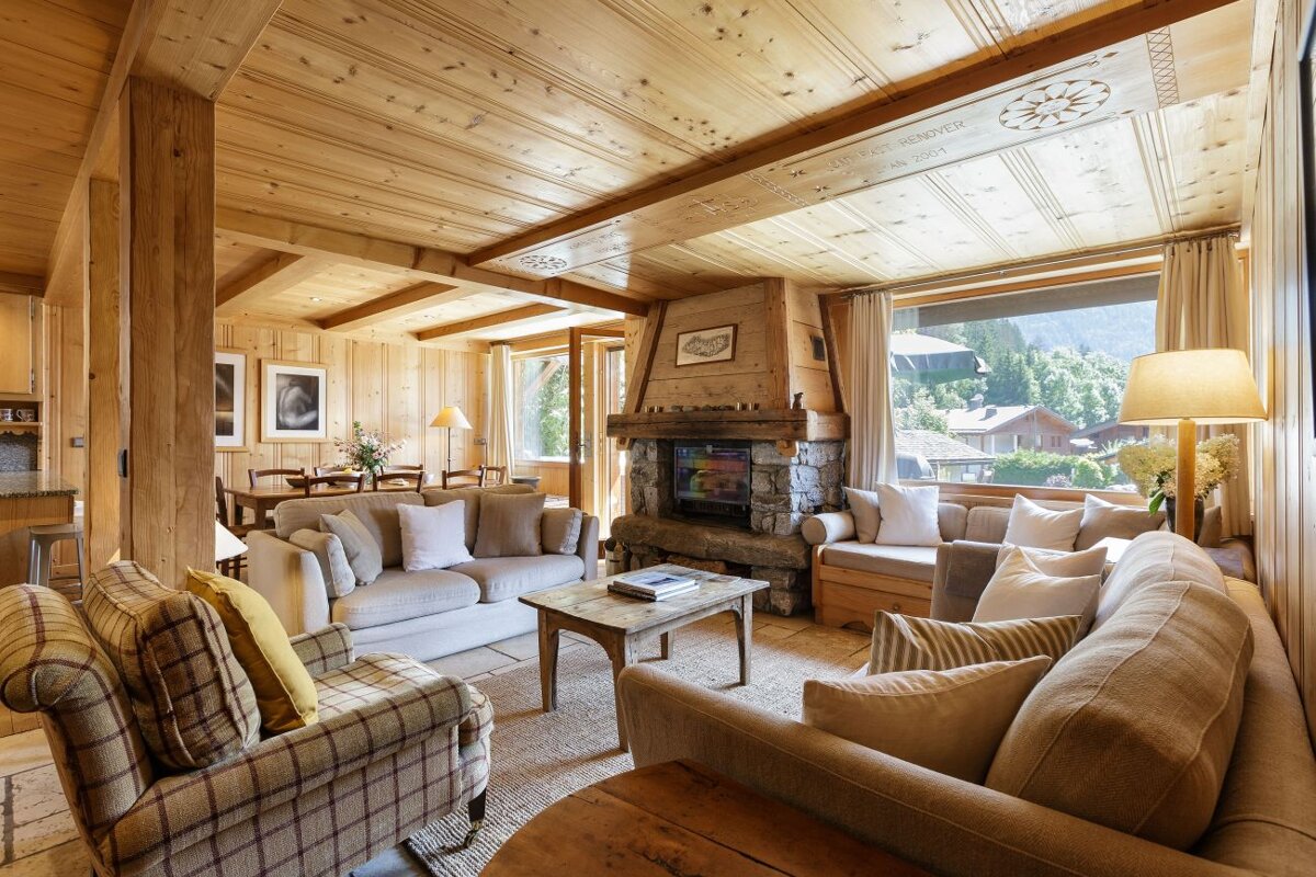 A living room with a couch a chair and a fireplace