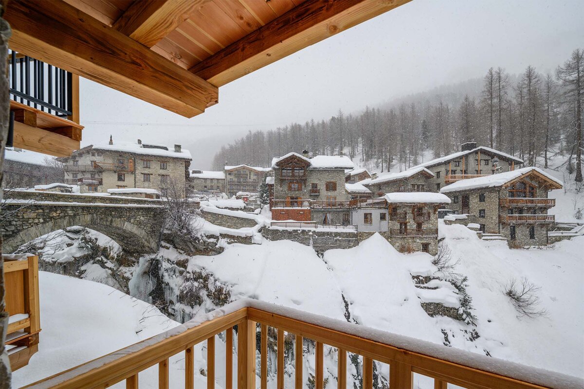 A view of a snowy village from a balcony