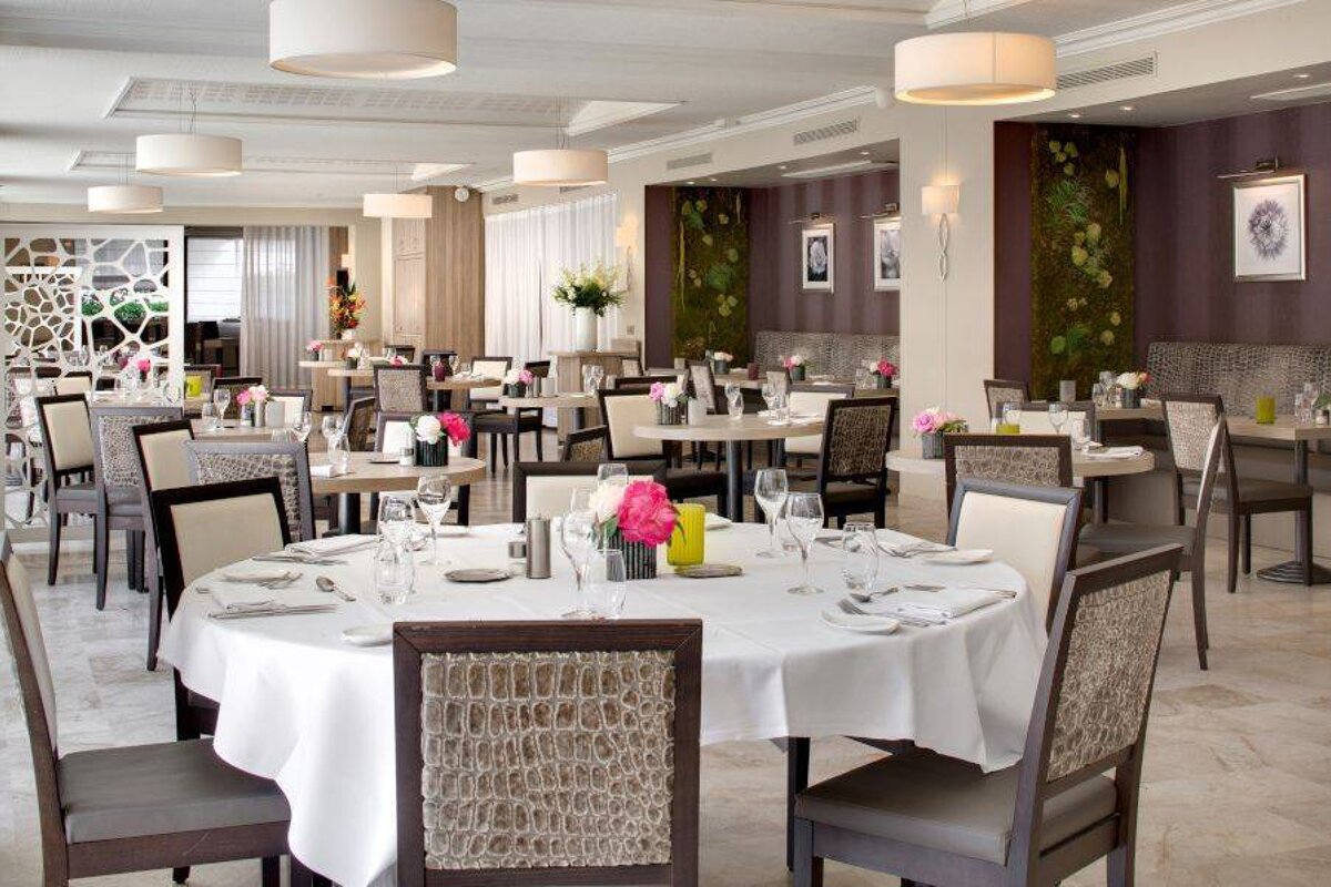 A large dining room with tables and chairs set for dinner