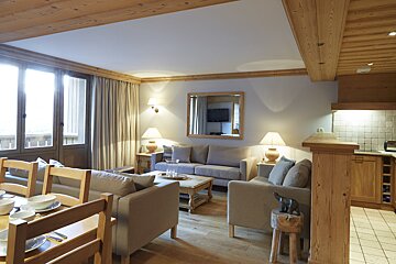 A living room with a couch a chair and a table