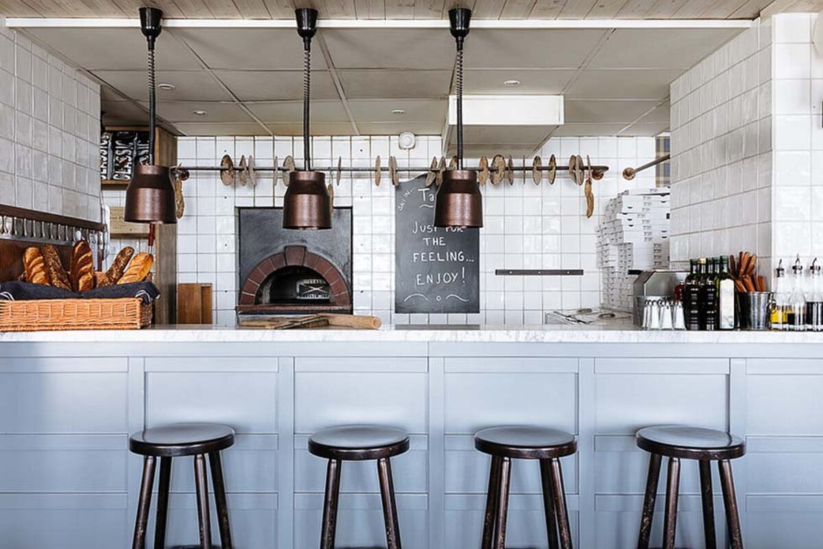 A restaurant with a chalkboard that says 