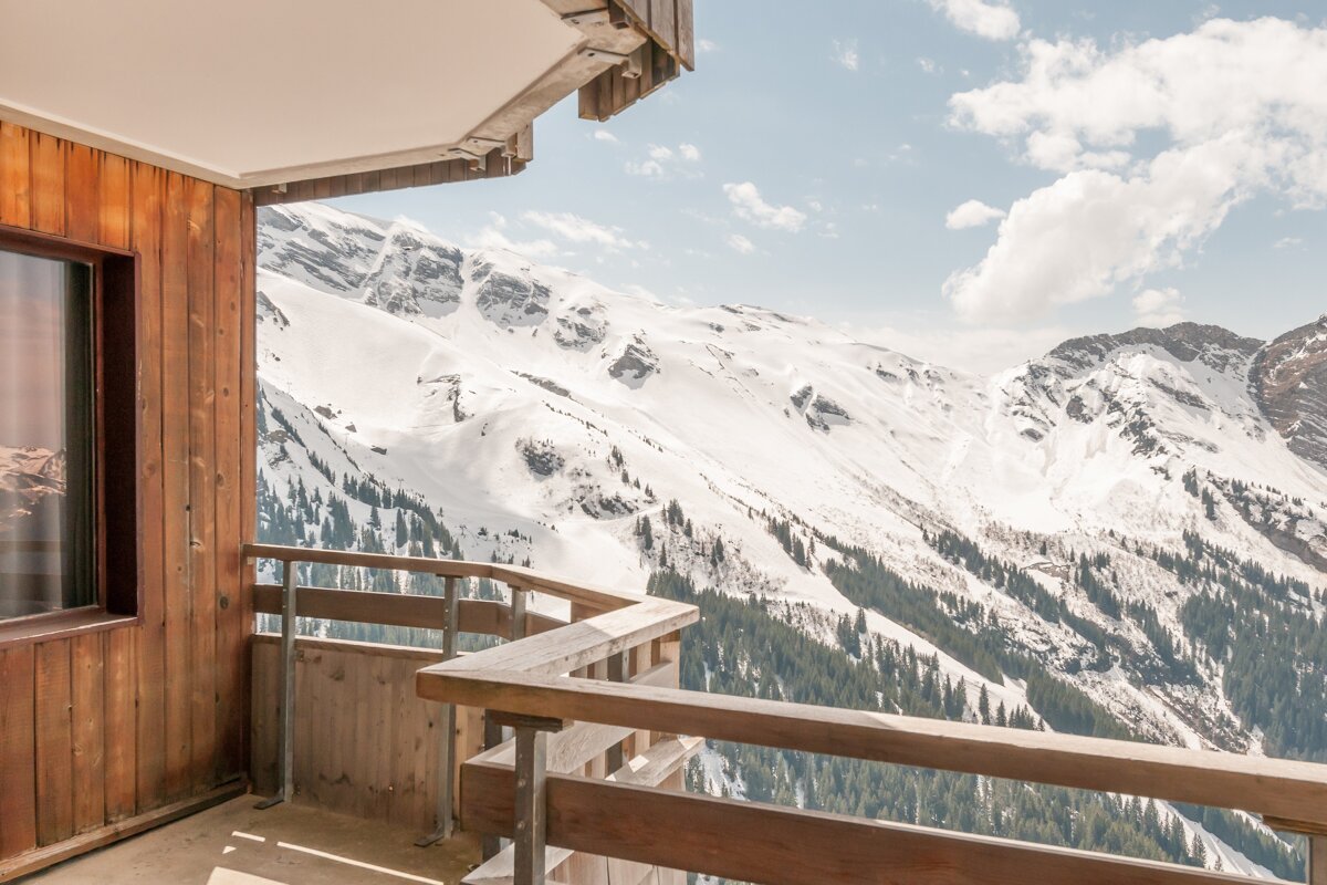 A balcony with a view of snow covered mountains