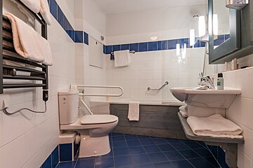 A bathroom with a toilet a sink and a bathtub