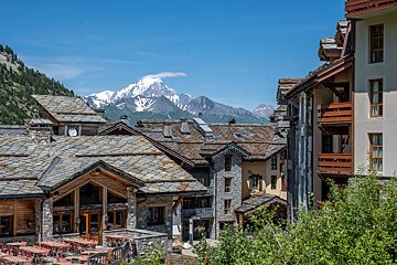 A row of buildings with a mountain in the background