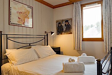 A bedroom with a map of france on the wall above the bed