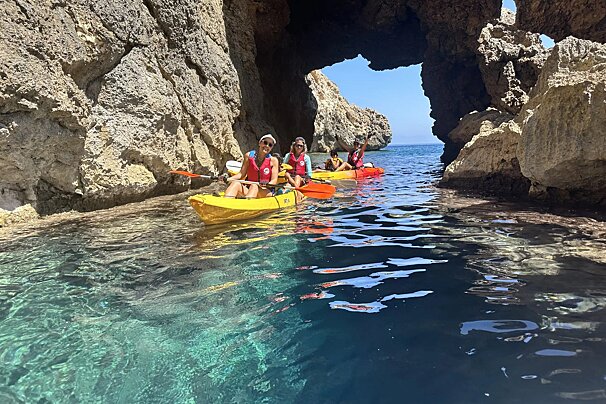 A group of people in kayaks in a cave