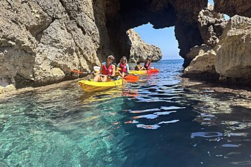 A group of people in kayaks in a cave