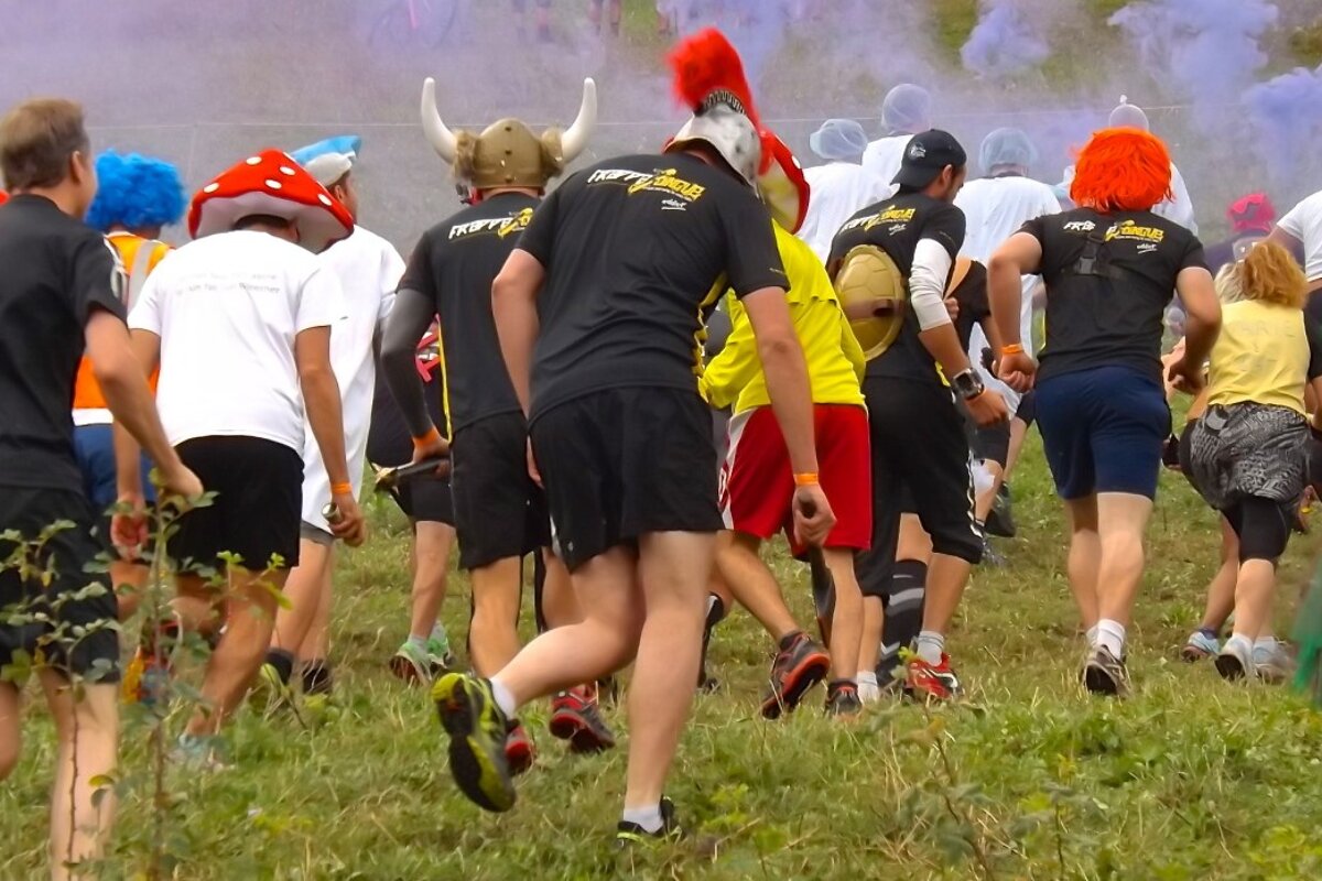 people running off up hill in fancy dress