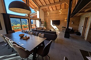 A living room with a large table and chairs