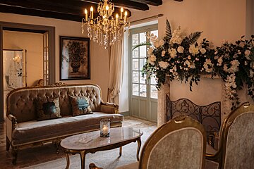 A living room with a couch and a fireplace decorated with flowers