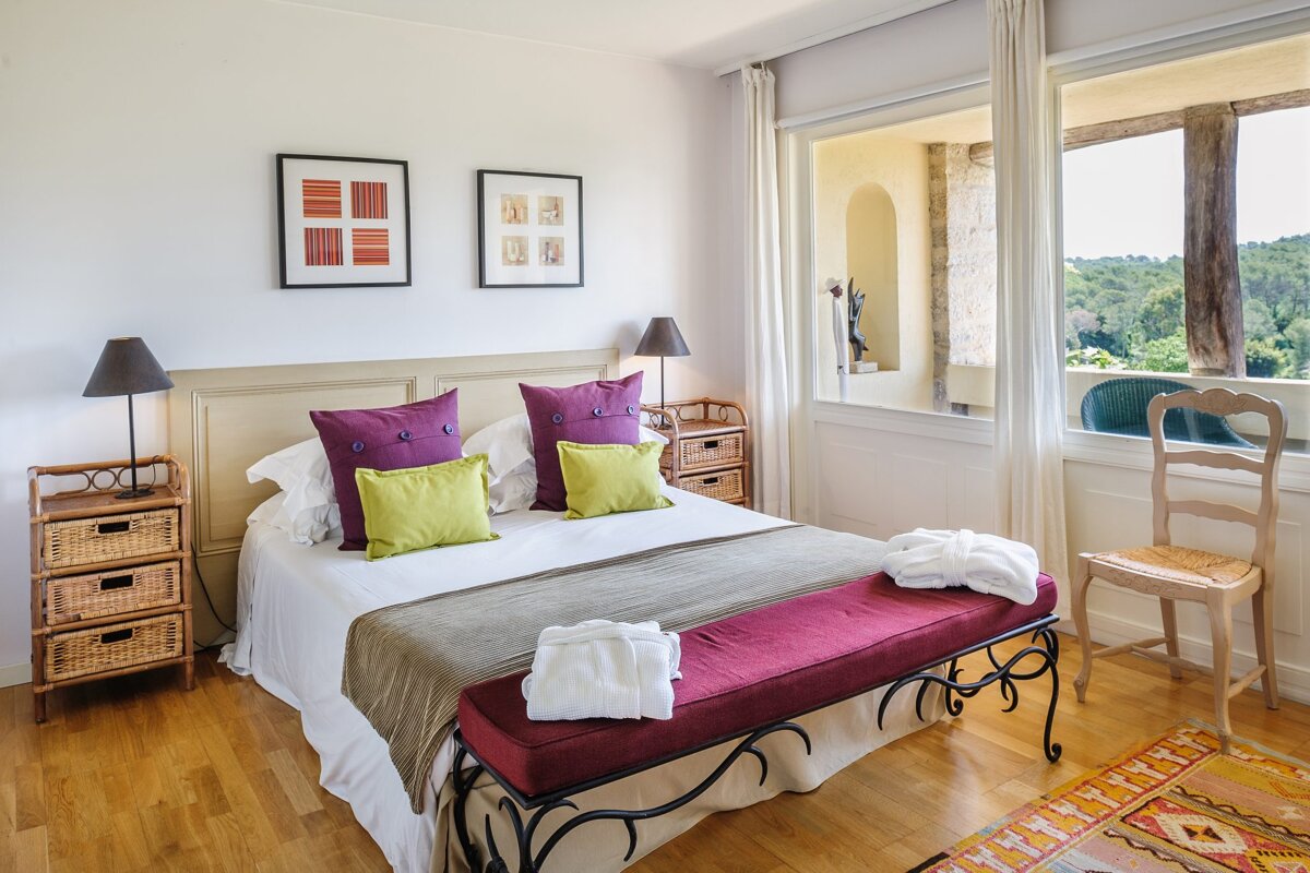 A bedroom with a large bed and a window