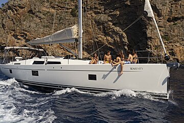 A group of people sit on a sailboat called serenity