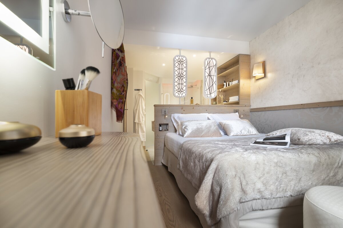 A bedroom with a bed and a book on the bed