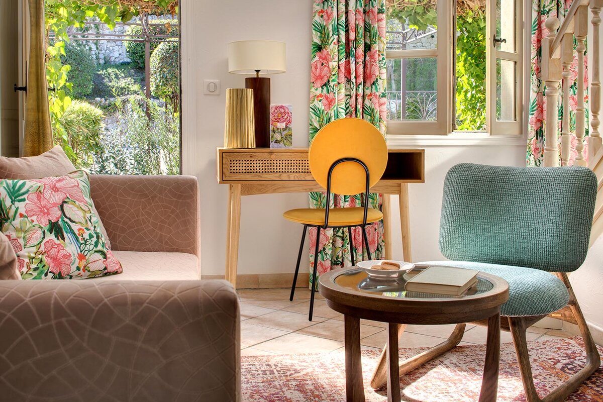 A living room with a yellow chair and a blue chair