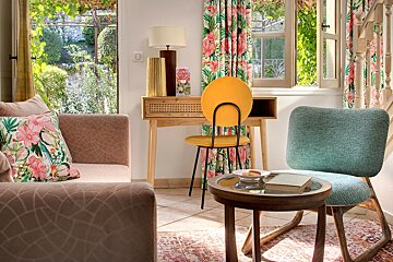 A living room with a yellow chair and a blue chair