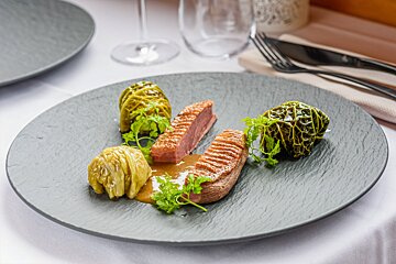 A plate of food with meat and cabbage on a table