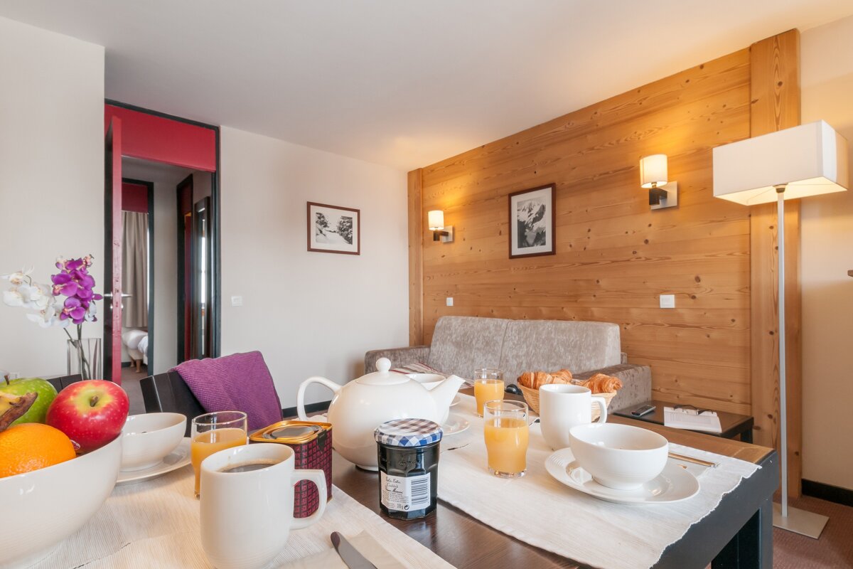 A jar of jam sits on a table in a living room