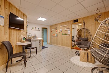 A room with a hanging chair and a sign that says