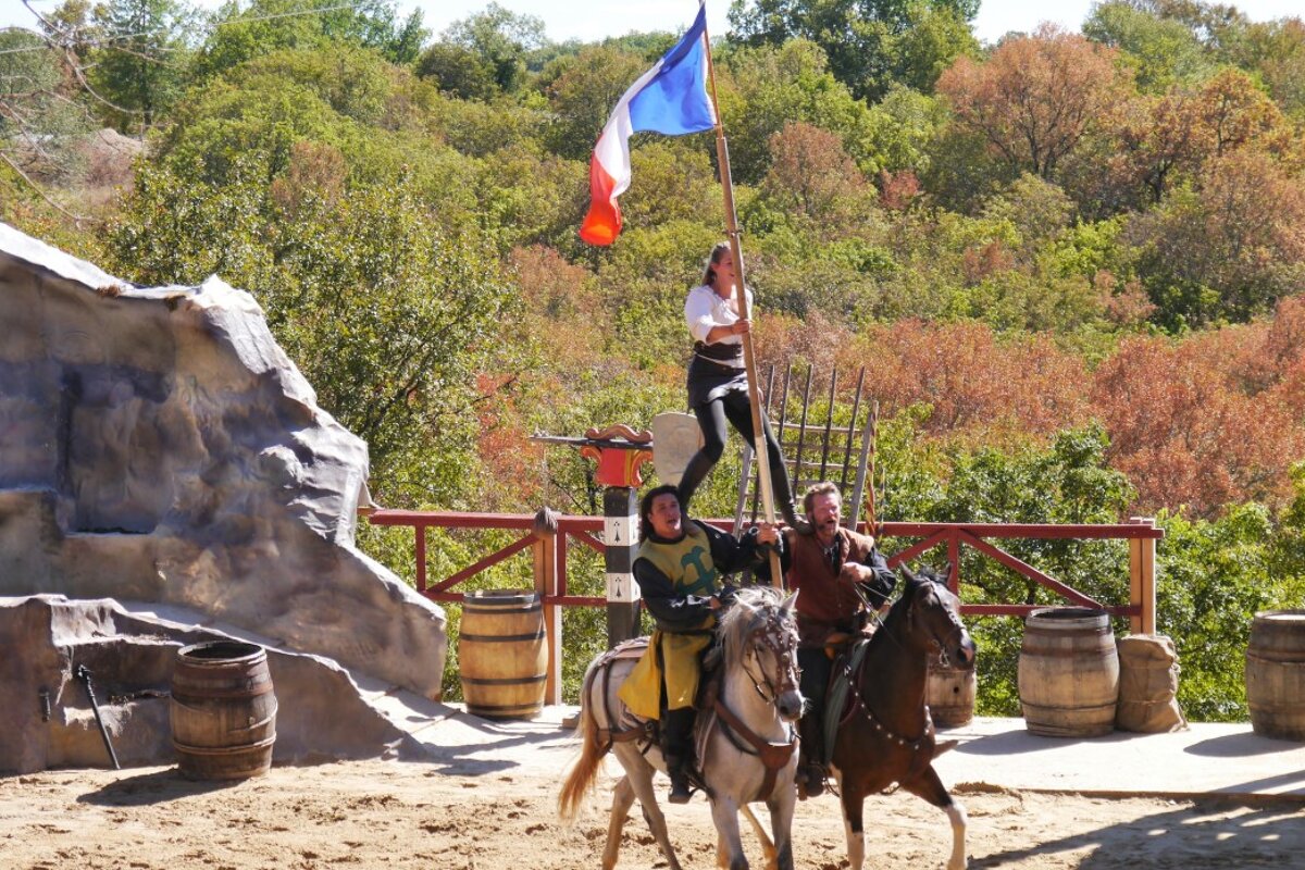 a woman on men's shoulders on horseback