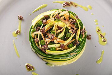 A plate of food with vegetables and sauces on it