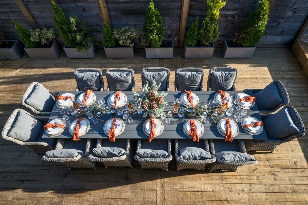 A long table with plates and napkins on it