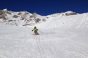 a man skiing on the pistes