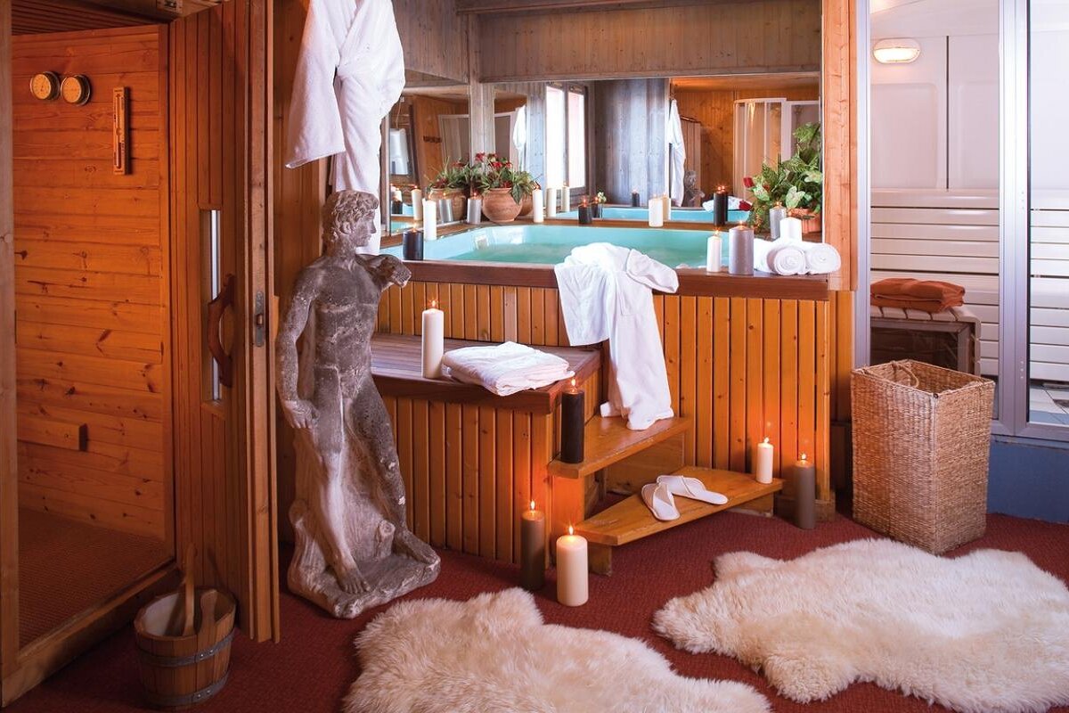 A bathroom with a statue of a man and candles