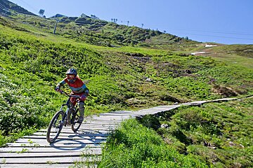 a woman on a mountain bike in verbier
