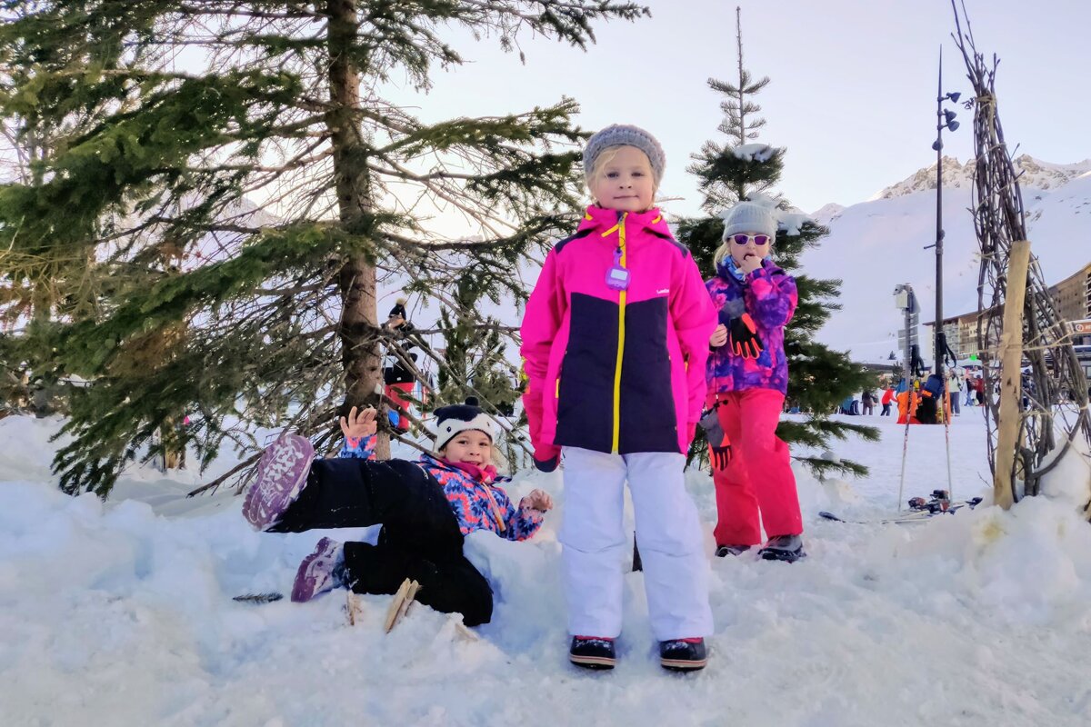 A little girl in a pink jacket with the word decathlon on it