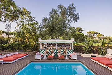 A swimming pool with a bar in the background