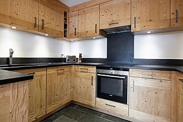 A kitchen with stainless steel appliances and wooden cabinets