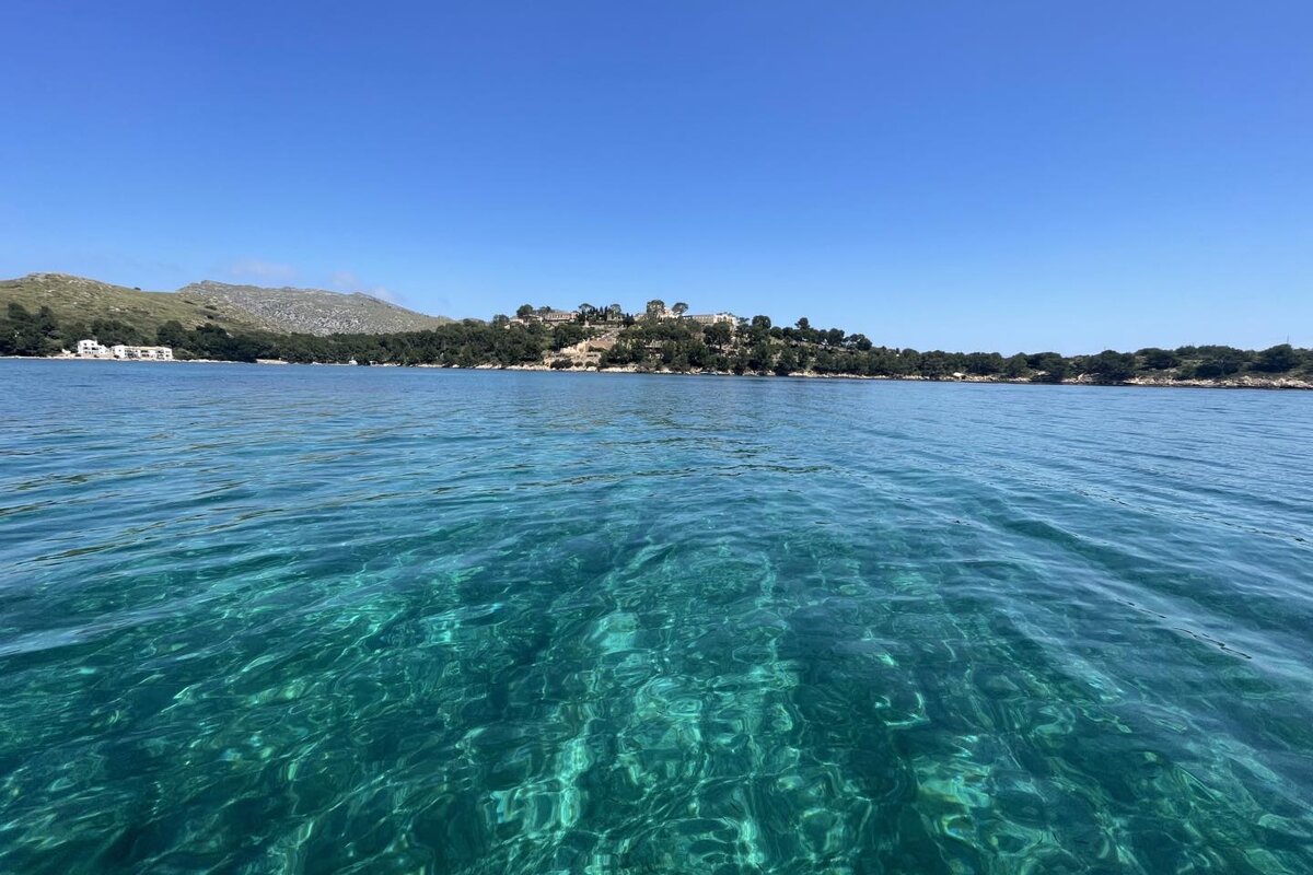 A large body of water with a small island in the background