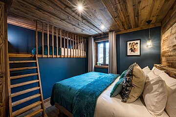 A bedroom with a bunk bed and a poster on the wall