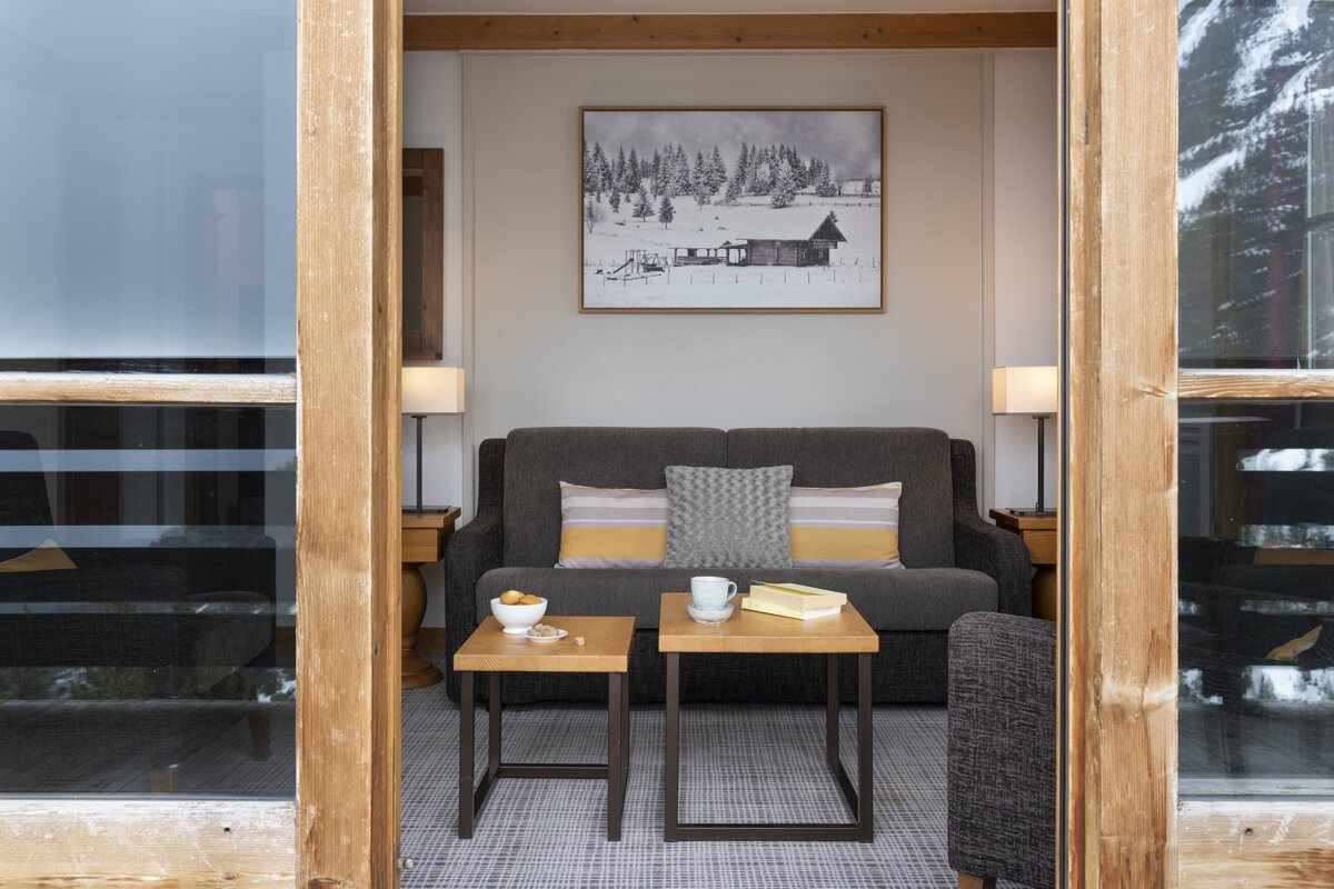 A living room with a couch and a picture on the wall