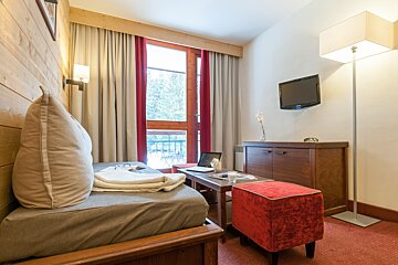 A small room with a couch and a television