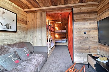 A living room with a couch and bunk beds