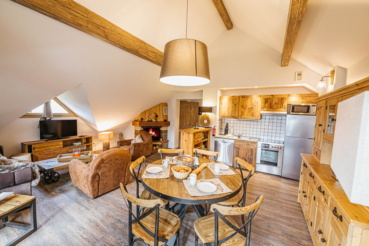 A living room with a dining table and chairs