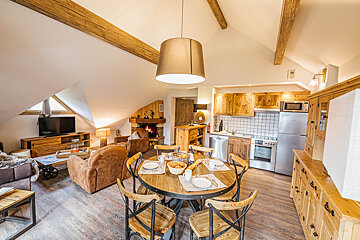 A living room with a dining table and chairs